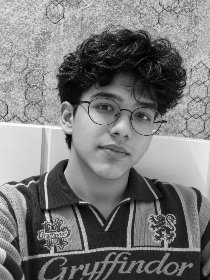 Nalin Aggarwal in a Gryffindor sweater, photographed in black and white